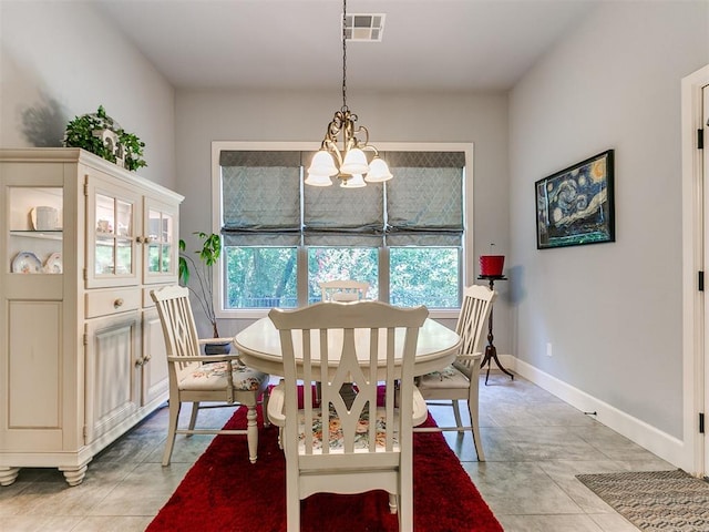 dining area featuring an inviting chandelier and light tile patterned flooring