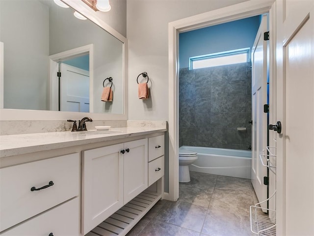 full bathroom with tile patterned flooring, vanity, toilet, and tiled shower / bath