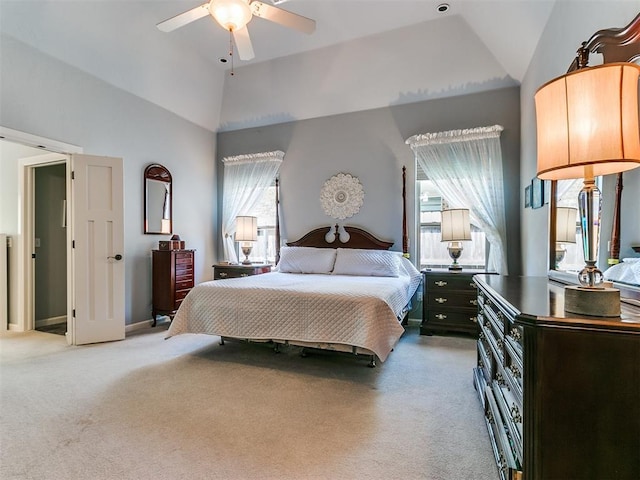 bedroom featuring light colored carpet, lofted ceiling, and multiple windows