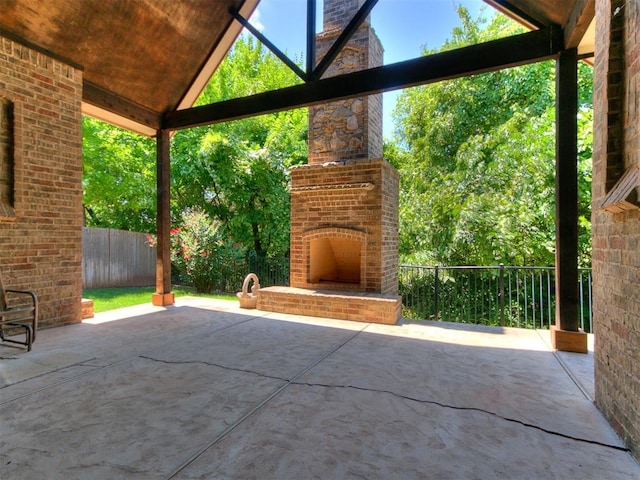 view of patio with an outdoor brick fireplace