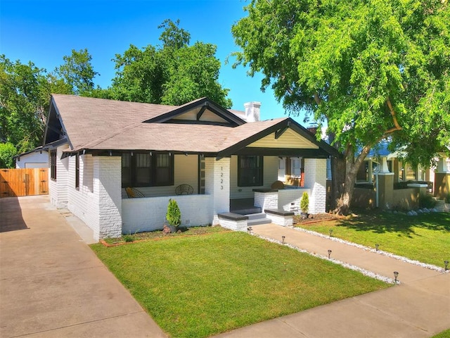 bungalow-style house featuring a porch and a front lawn