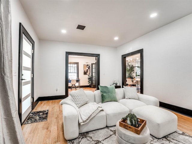 living room featuring light hardwood / wood-style flooring and a healthy amount of sunlight