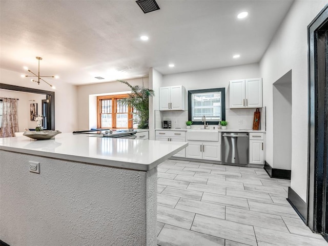 kitchen featuring a healthy amount of sunlight, sink, white cabinets, and stainless steel appliances