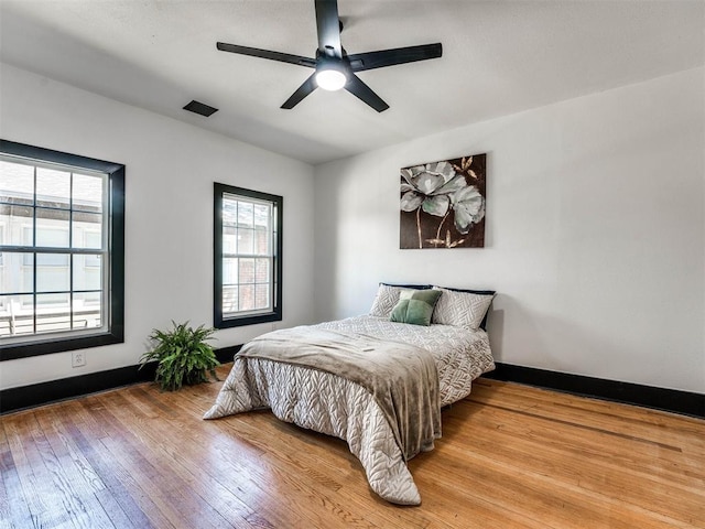 bedroom with ceiling fan and light wood-type flooring