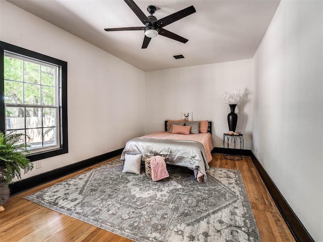 bedroom featuring ceiling fan and hardwood / wood-style flooring