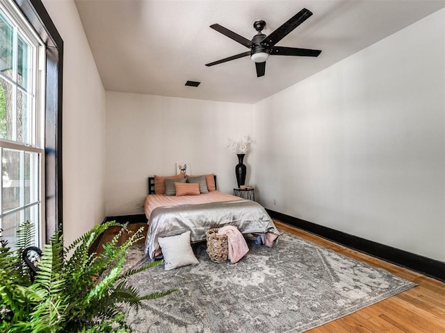 bedroom featuring ceiling fan and hardwood / wood-style flooring