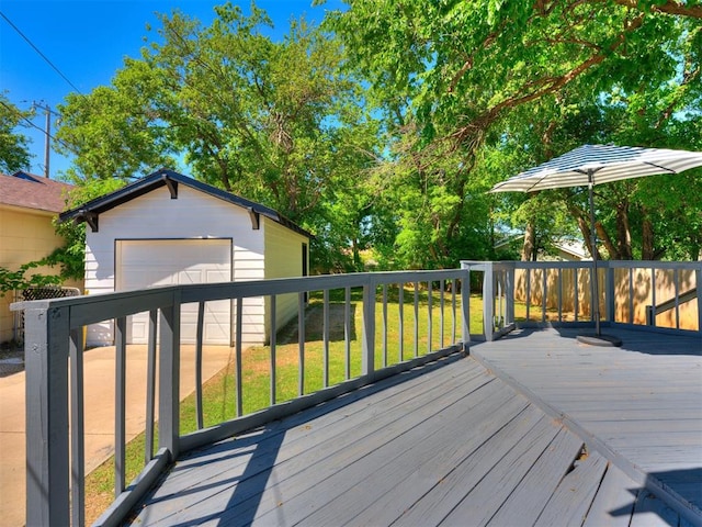 wooden deck featuring an outbuilding, a garage, and a lawn