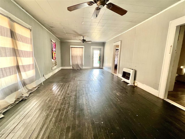 unfurnished living room featuring crown molding, dark wood-type flooring, and heating unit