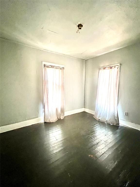 unfurnished room featuring dark hardwood / wood-style floors