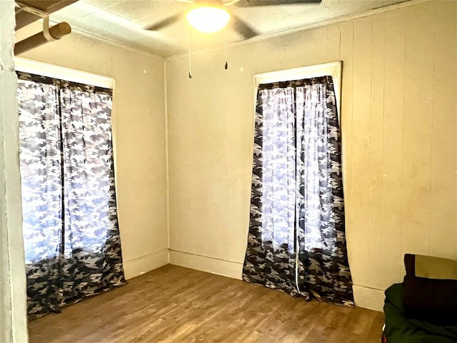 unfurnished room with ceiling fan and wood-type flooring