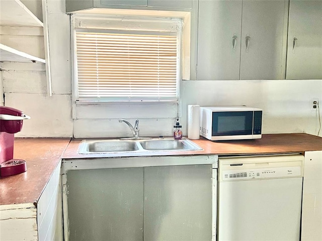 kitchen featuring sink and white appliances