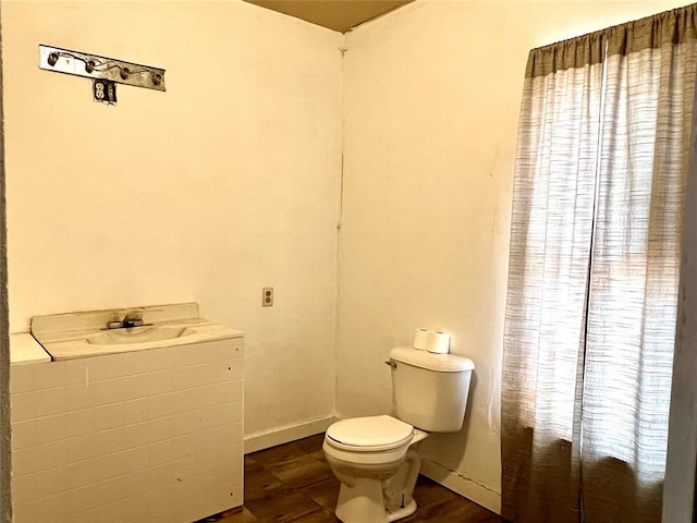 bathroom with wood-type flooring and toilet