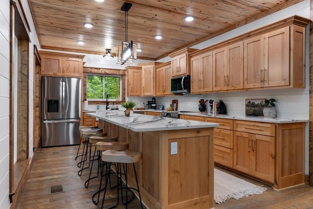 kitchen with appliances with stainless steel finishes, wood ceiling, pendant lighting, wood-type flooring, and a kitchen island