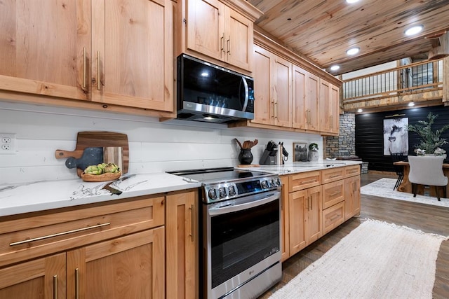 kitchen with light stone countertops, dark hardwood / wood-style flooring, wood ceiling, and appliances with stainless steel finishes