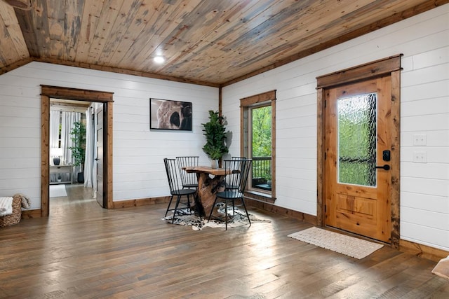 dining room featuring wood walls, dark hardwood / wood-style flooring, and wood ceiling