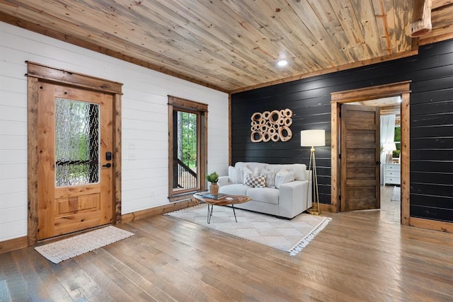 sitting room with wood walls, wood ceiling, and wood-type flooring