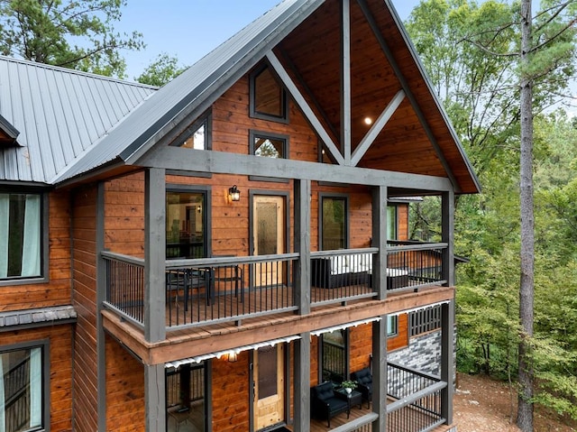 rear view of property featuring a balcony