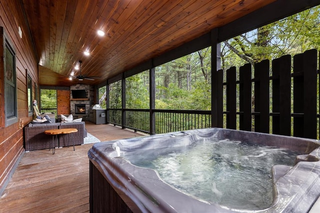 105 Western Pine Trl, Hochatown, OK 74728 - sunroom with a jacuzzi, an outdoor stone fireplace, lofted ceiling, wood ceiling, and ceiling fan