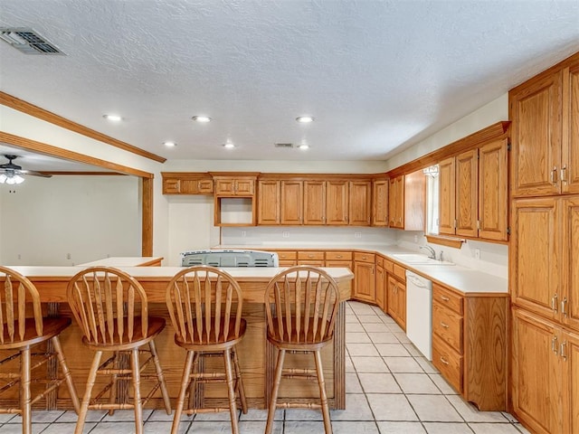 8015 County St Unit 2610, Hinton, OK 73047 - kitchen with white dishwasher, light tile patterned flooring, recessed lighting, a breakfast bar, and a center island