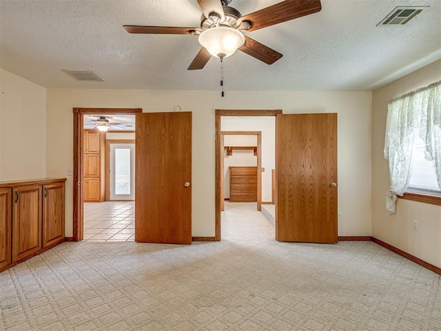 8015 County St Unit 2610, Hinton, OK 73047 - empty room with a ceiling fan, a textured ceiling, and light colored carpet