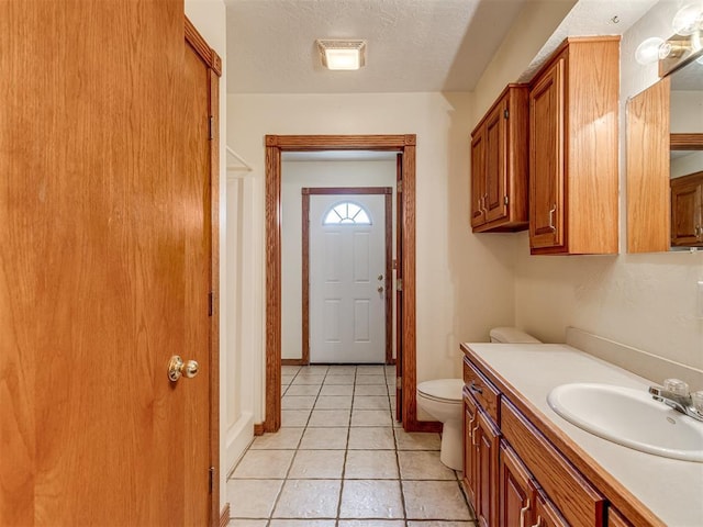 8015 County St Unit 2610, Hinton, OK 73047 - bathroom featuring vanity, tile patterned floors, and a textured ceiling