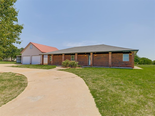 ranch-style house featuring a garage and a front lawn