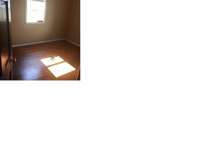 empty room with dark wood-type flooring