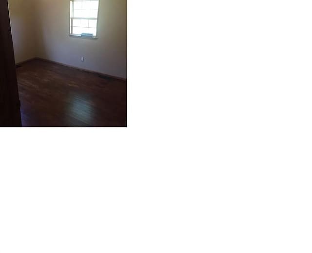 empty room featuring dark hardwood / wood-style flooring