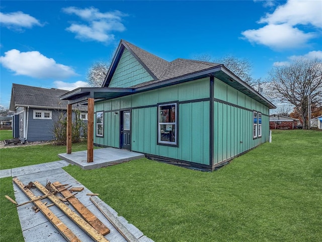 rear view of property featuring a yard and a patio