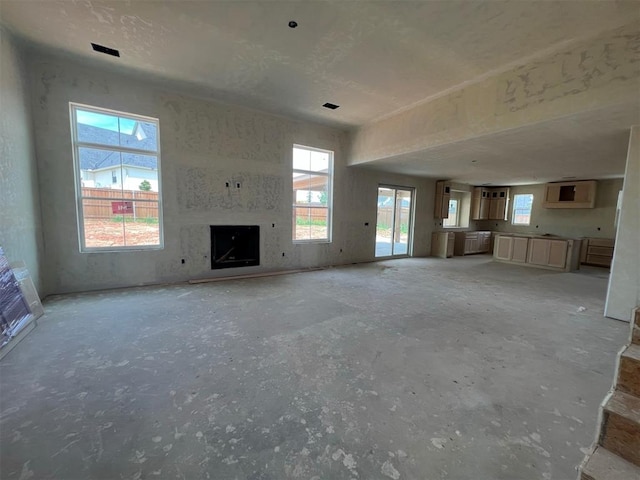 unfurnished living room featuring a wealth of natural light