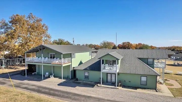 back of property with a balcony