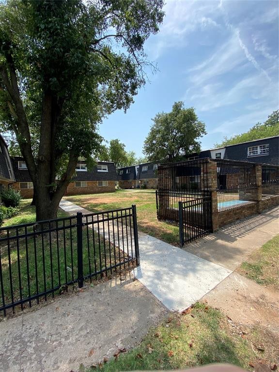 view of property's community featuring a yard and a swimming pool