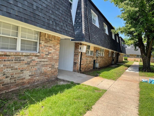 view of side of home featuring a lawn