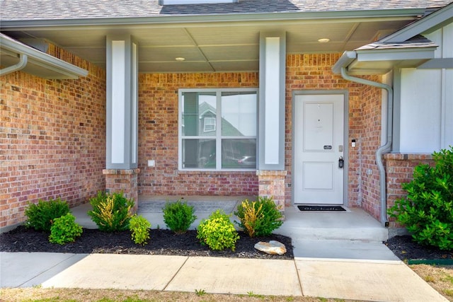 view of exterior entry with a porch