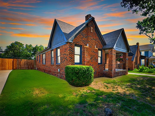 property exterior at dusk with a yard