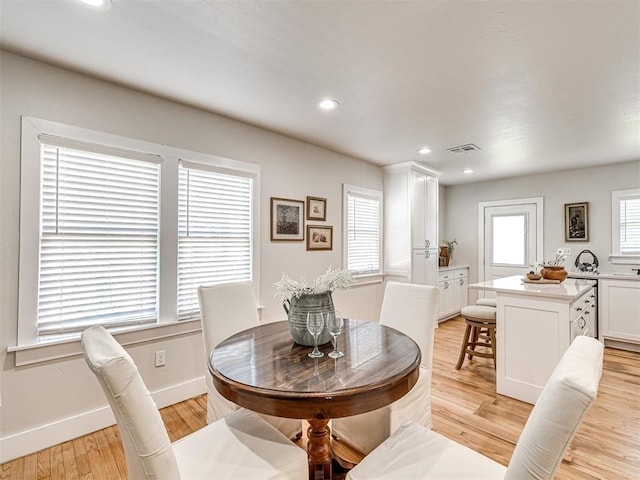 dining space with light wood-type flooring