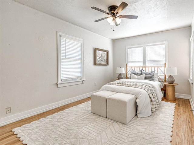 bedroom with light hardwood / wood-style floors and ceiling fan