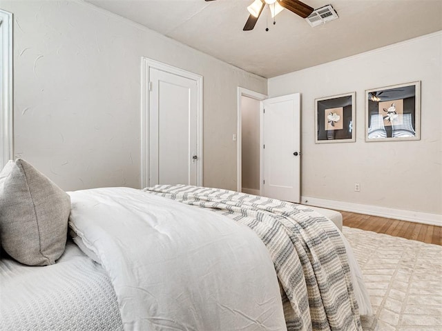 bedroom with ceiling fan and hardwood / wood-style flooring