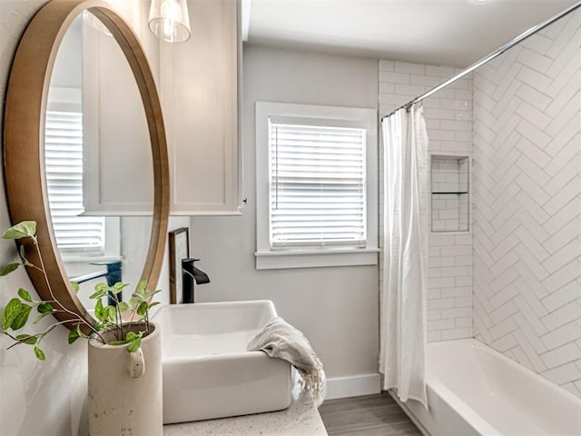 bathroom featuring shower / tub combo with curtain and hardwood / wood-style floors