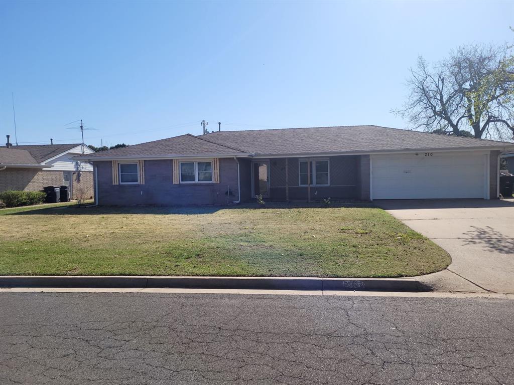 ranch-style house with a front yard and a garage