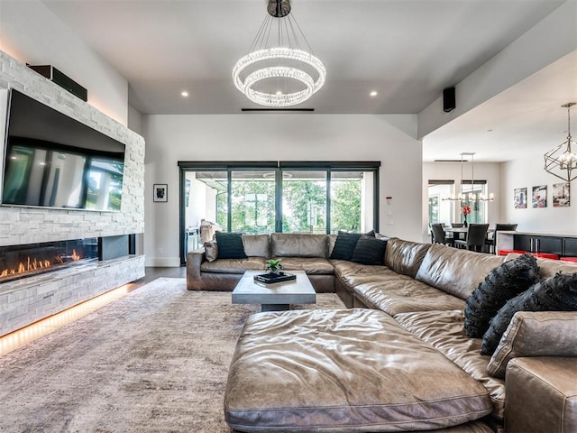 living room with a fireplace, hardwood / wood-style floors, and a notable chandelier