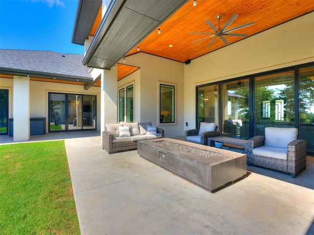 view of patio with ceiling fan and an outdoor living space with a fire pit