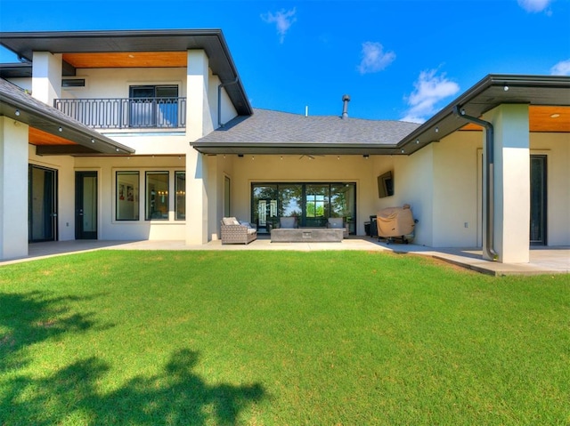 back of house featuring outdoor lounge area, a yard, a balcony, and a patio area