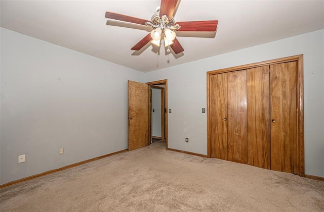 unfurnished bedroom featuring carpet floors, a closet, and ceiling fan