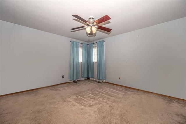 empty room featuring ceiling fan and light carpet