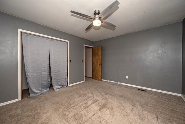 unfurnished bedroom featuring carpet, a closet, and ceiling fan