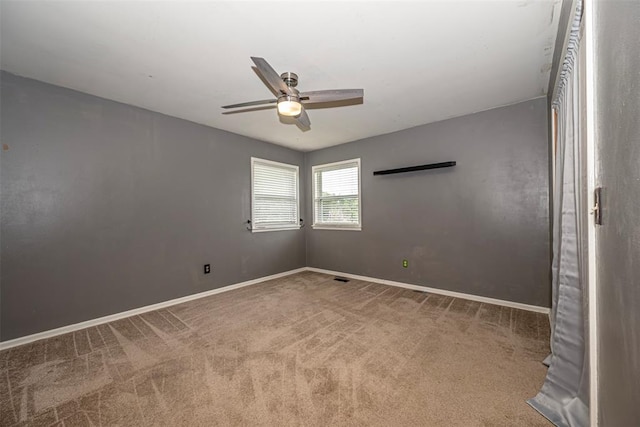 unfurnished room with ceiling fan and carpet floors