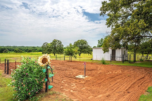 view of yard with a rural view and an outdoor structure