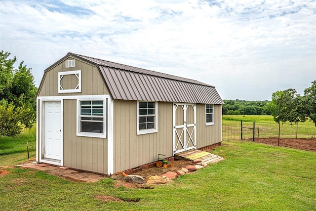 view of outbuilding with a yard