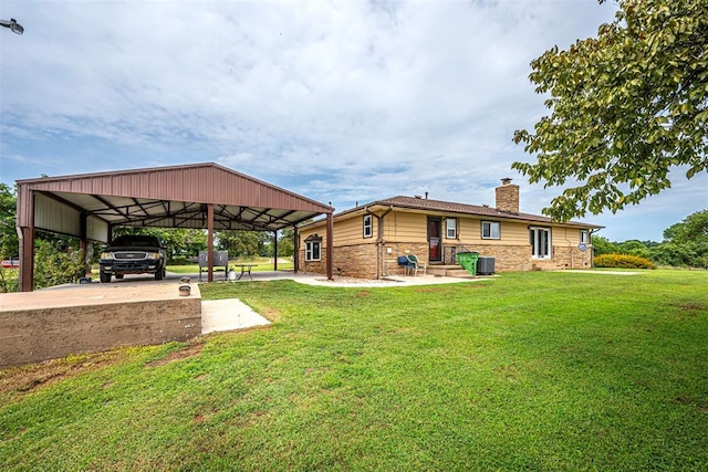 rear view of property featuring a yard and a carport